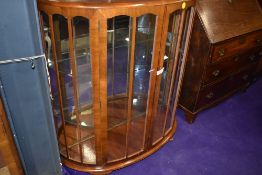 An art deco display or cocktail cabinet having mirror back and glazed frontage