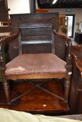 A Victorian carver chair having bow arms on turned frame stretchers