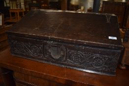 A Jacobean style early 19th century bible box or bureau top having heavily carved oak frontage