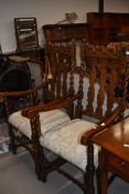 A pair of early 20th Century oak twist frame and shaped railback carver chairs having later