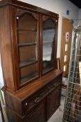 A Victorian secretaire book case having mahogany frame work with rolled glass front and decorative