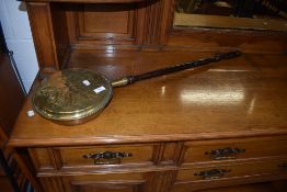 A traditional brass warming pan
