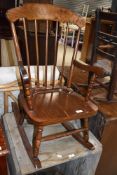 A vintage stained frame and ply child's rocking chair