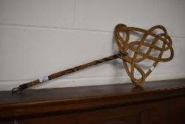 A traditional canework carpet beater