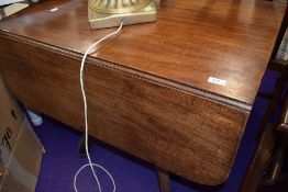 An antique mahogany fold out tea or breakfast table having one under drawer and one false