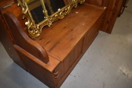 A natural pine box settle