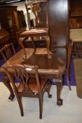 A Victorian dining table having mahogany frame with carved animal feet and a matching set of four