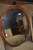 An early 20th Century mahogany oval wall mirror, approx 65 x 50cm