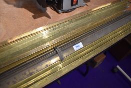 A collection of vintage brass stair rods.