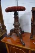 A late 18th century piano stool having turned frame on tripod base with carved sides in mahogany