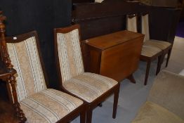 A vintage G plan gateleg dining table and four similar upholstered dining chairs