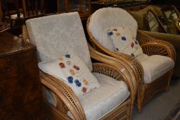 A pair of conservatory easy chairs