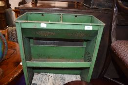 A metal framed utility shelf or vegetable storage unit