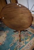A mid Victorian tilt top tea table having mahogany frame with carved animal feet