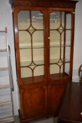 A nice quality reproduction bookcase/display cabinet with cupboard under (some glass damaged hence