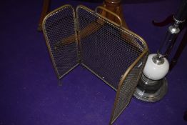 A vintage brass fire guard