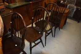 A set of four dark stained hoop and stick back dining chairs (similar to Ercol)