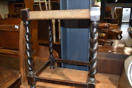 A vintage woven fibre topped stool having barley twist legs