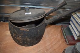 Two cast iron pans, one large one having lid.