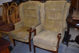 A pair of modern stained frame wing back easy chairs