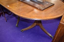 A late 19th or early 20th Century Regency revival mahogany extending dining table having centre