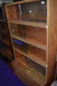 A vintage simplex stacking bookcase, 5 tiers in total, light colour
