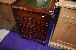 A modern reproduction double file drawer base having green leather top