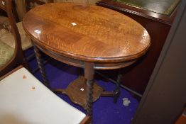An Edwardian console or side table having barley twist oak legs and frame work