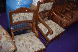 A 19th Century mahogany upholstered armchair having semi spindle back, and a matching nursing chair