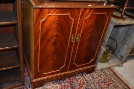 A reproduction Regency style TV cabinet