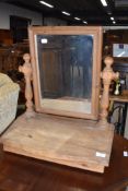 A natural rustic pine toilet mirror with sloped flap base
