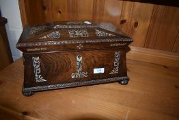 A 19th Century mhogany tea caddy of sarcophagus form with mother of pearl inlay and fitted interior