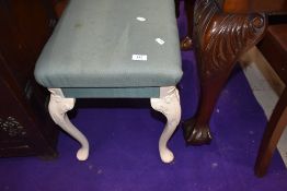 a modern reproduction piano or similar stool having carved legs