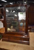 A Victorian dressing table mirror having lame mahogany veneer and silvered mirror back
