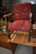 An early 20th Century oak twist frame low armchair