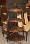 A 19tgh Century burr walnut corner whatnot having four tiers, all with satinwood inlay