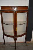 An early 20th Century mahogany demi lune display cabinet on triple cabriole legs, width approx.