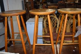 A set of three vintage bar height kitchen stools