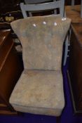 A vintage nursing chair with moquette style upholstery on stained frame