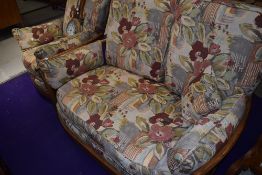 A mid century style Ercol two seater couch and matching arm chair in a mid stain