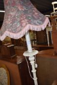 A modern standard lamp having turned and carved base