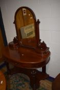 A Victorian wash stand having mahogany carcass with mirror back and carved legs on bun feet very