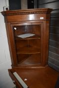 A traditional oak glazed corner display of small proportions
