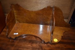 A light oak wall mounted corner shelf