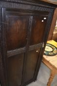 A traditional gentleman's wardrobe, in dark oak, interior labelled for Fitrobe Ltd