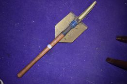 A vintage folding shovel.