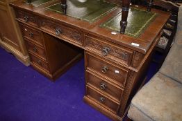 A modern Jaycee pedestal desk having carved oak frontage with green leather top