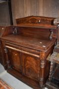 A Victorian mahogany sideboard having shelf back, turned column, concealed frieze drawer and