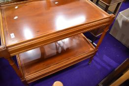 A modern yew wood tea or drinks trolley