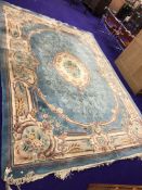 A modern carpet square having an oriental blue ground